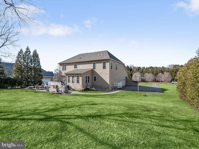 rear view of house with a yard and a patio area