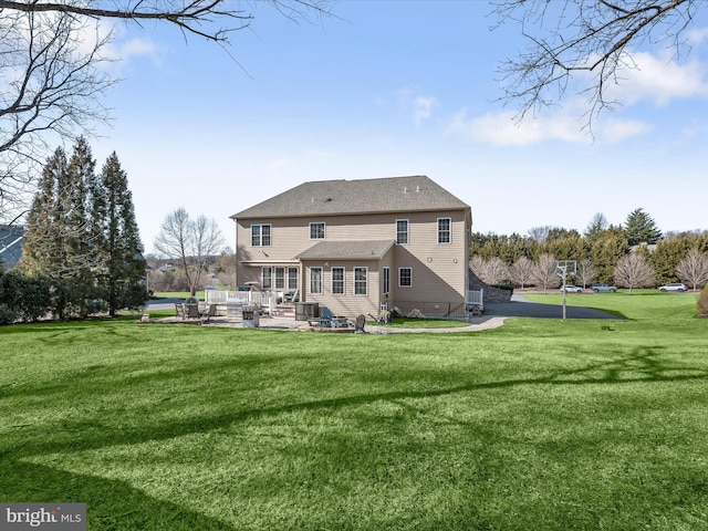 back of property featuring a lawn, central AC, and a patio area