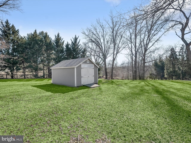 view of yard with a storage unit, an outbuilding, and fence