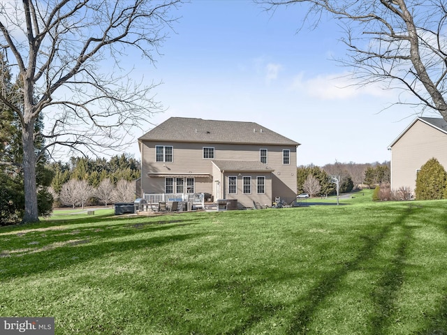 rear view of property with a yard