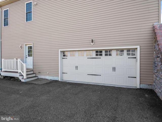 garage with aphalt driveway