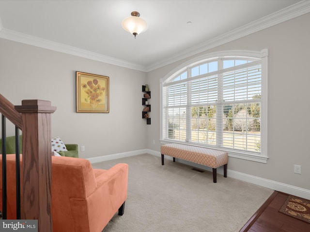 living area featuring stairway, light colored carpet, baseboards, and ornamental molding