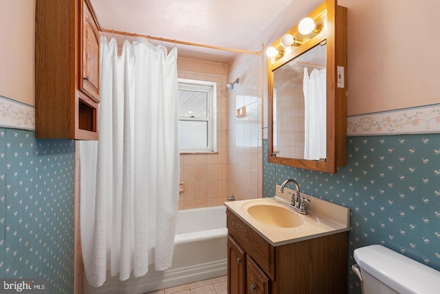 bathroom featuring toilet, wallpapered walls, tile patterned flooring, and shower / bath combo with shower curtain