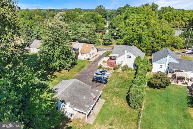 birds eye view of property with a forest view and a residential view