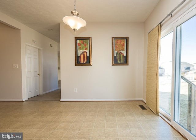 empty room featuring visible vents and baseboards