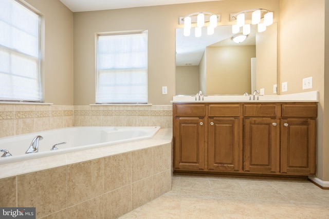 bathroom with a garden tub, double vanity, a sink, and tile patterned floors