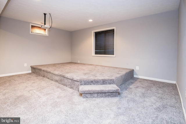 unfurnished bedroom featuring carpet, baseboards, and recessed lighting