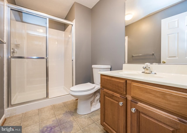 bathroom featuring vanity, tile patterned flooring, a shower stall, and toilet