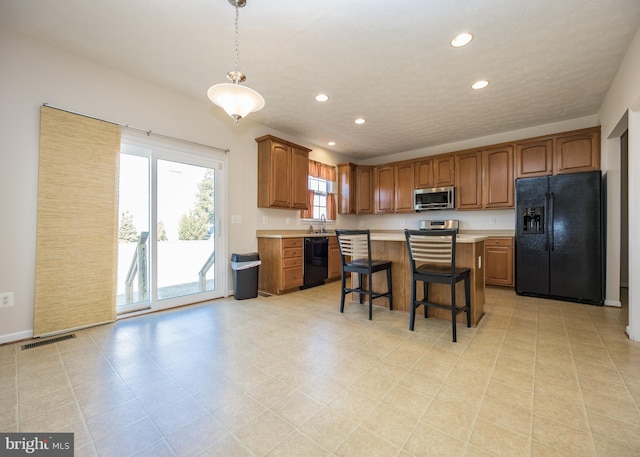 kitchen featuring black appliances, light countertops, visible vents, and recessed lighting