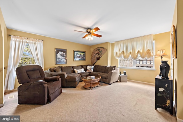 living room with carpet floors, visible vents, and ceiling fan