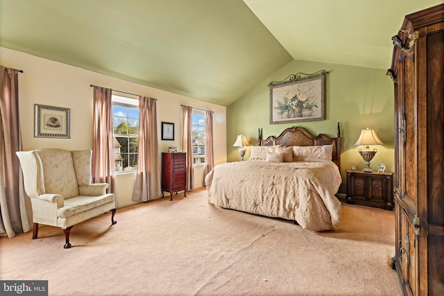 carpeted bedroom with lofted ceiling