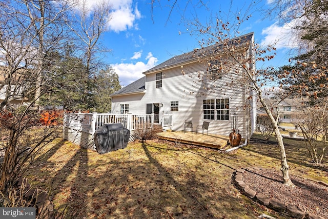 back of house with a wooden deck