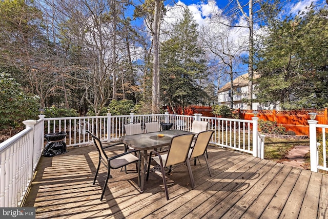 wooden terrace featuring outdoor dining area and fence