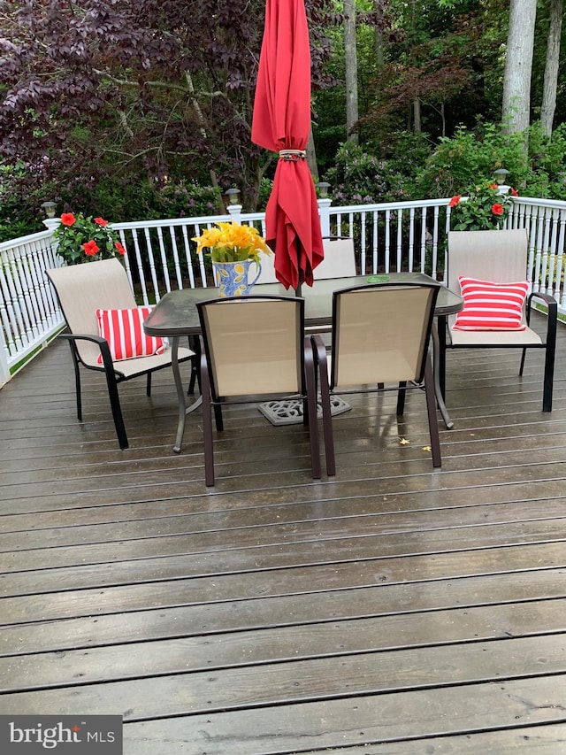 wooden terrace with outdoor dining area