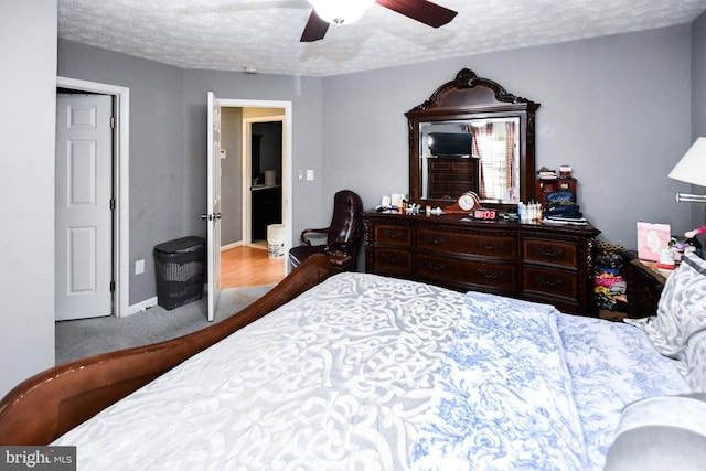 bedroom featuring ceiling fan, baseboards, and a textured ceiling