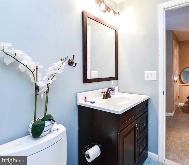 bathroom featuring baseboards and vanity