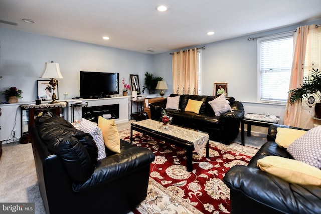 living area featuring carpet flooring and recessed lighting