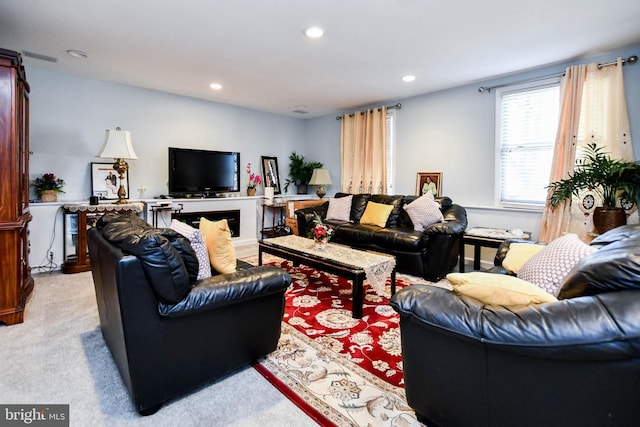 living area featuring recessed lighting and light carpet