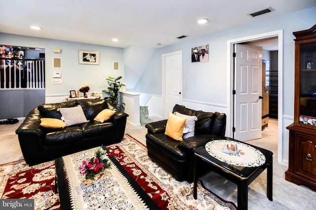 carpeted living area with recessed lighting and visible vents