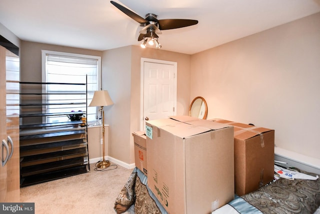 interior space with baseboards and ceiling fan