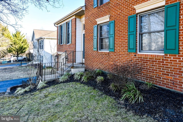 view of property exterior with brick siding