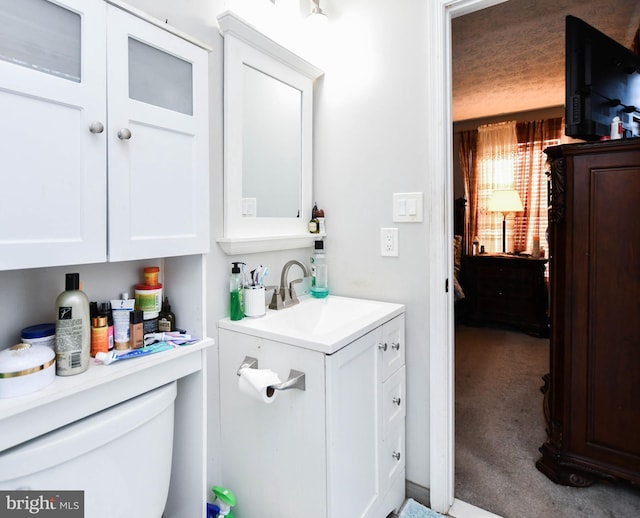 half bath featuring vanity and toilet