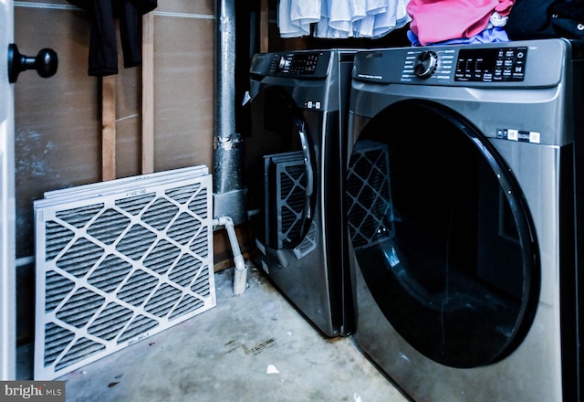 clothes washing area with washer and dryer and laundry area