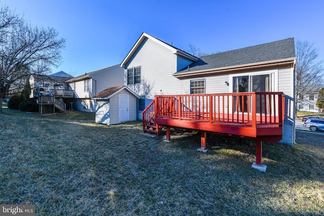 rear view of house with an outbuilding, stairway, a wooden deck, a storage shed, and a lawn