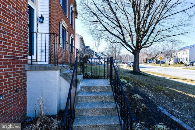 exterior space featuring a residential view and brick siding