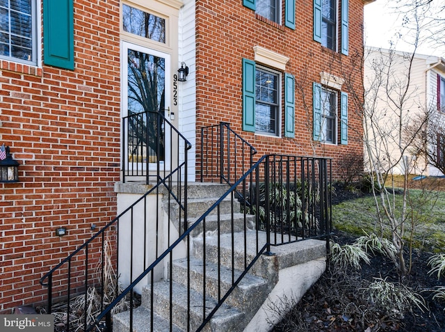 doorway to property with brick siding