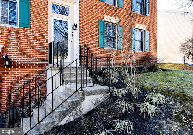 property entrance with brick siding