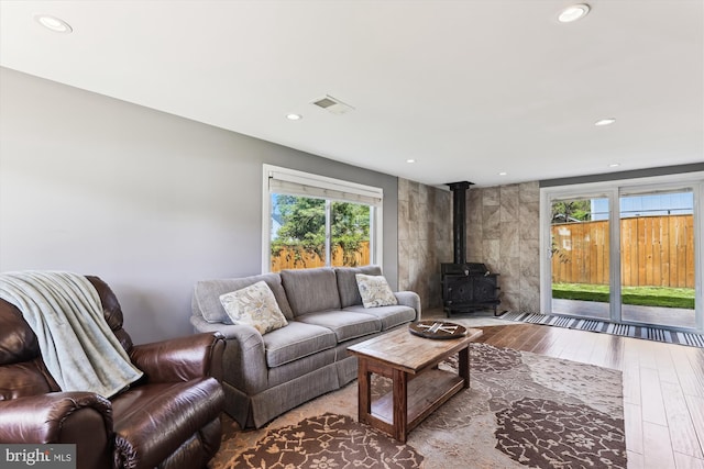 3246 Blundell Rd, Falls Church, VA 22042 - living area with a wealth of natural light, a wood stove, hardwood / wood-style floors, and visible vents
