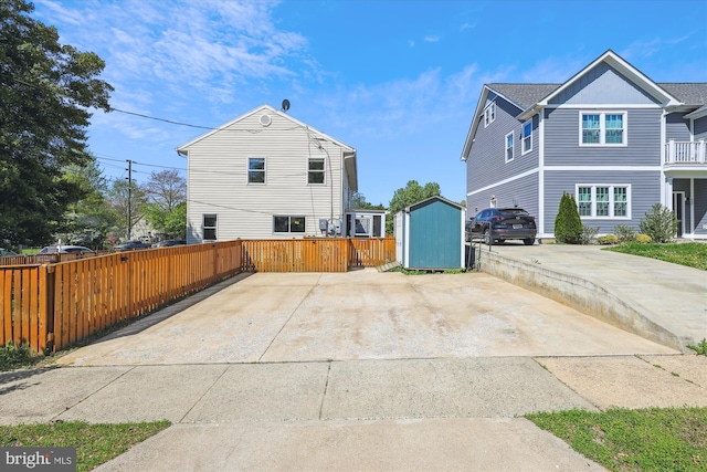 3246 Blundell Rd, Falls Church, VA 22042 - view of side of home featuring fence, a storage unit, and an outdoor structure