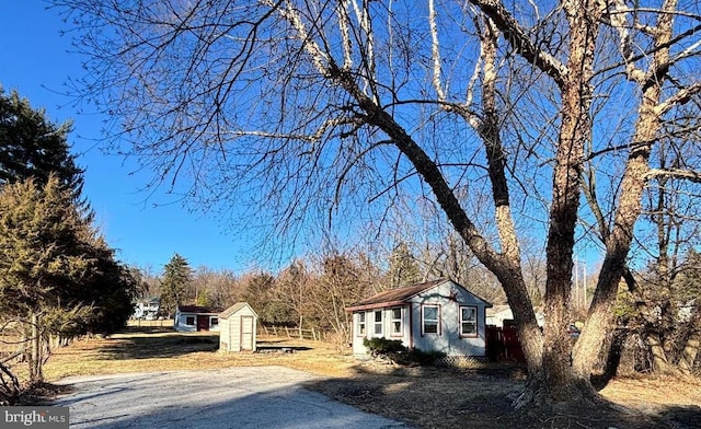 exterior space featuring an outbuilding and a storage unit