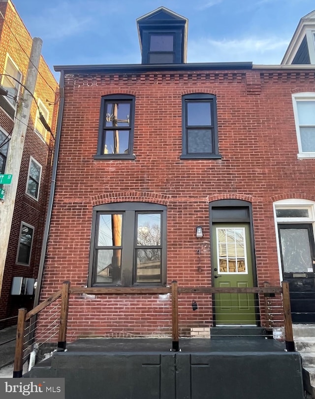 view of front of property featuring brick siding