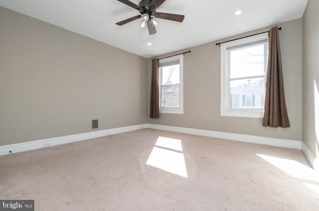 unfurnished room with recessed lighting, light colored carpet, visible vents, baseboards, and vaulted ceiling