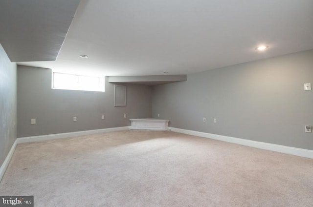 basement featuring light carpet, recessed lighting, and baseboards