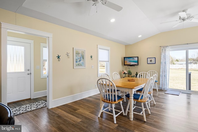 dining space with vaulted ceiling, dark wood-style floors, baseboards, and a wealth of natural light