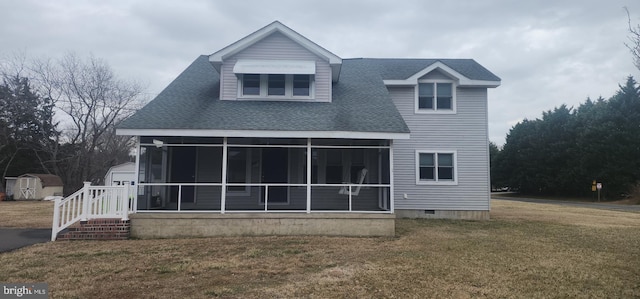 back of property with an outbuilding, roof with shingles, a yard, a sunroom, and a storage shed