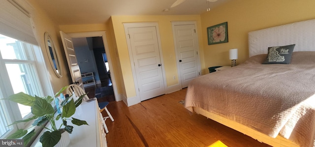 bedroom featuring light wood-type flooring, baseboards, and a closet