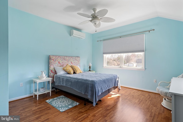 bedroom featuring a wall unit AC, wood finished floors, baseboards, ceiling fan, and vaulted ceiling