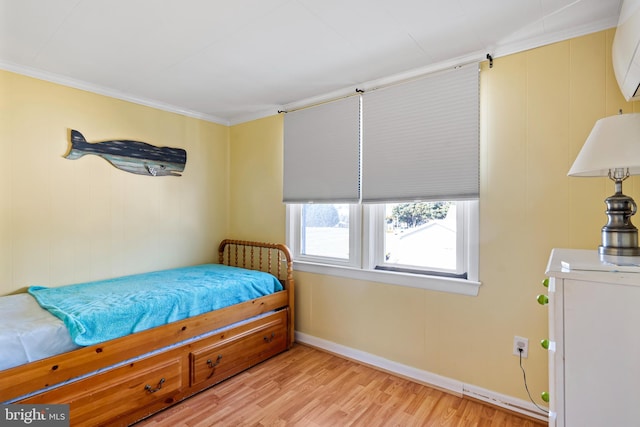 bedroom with baseboards, light wood-style floors, and ornamental molding