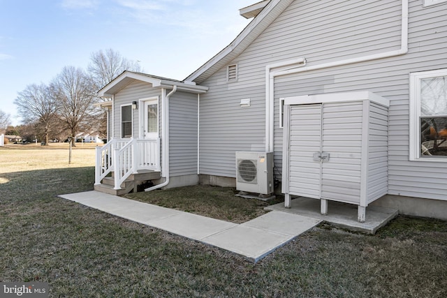 exterior space featuring ac unit and a yard