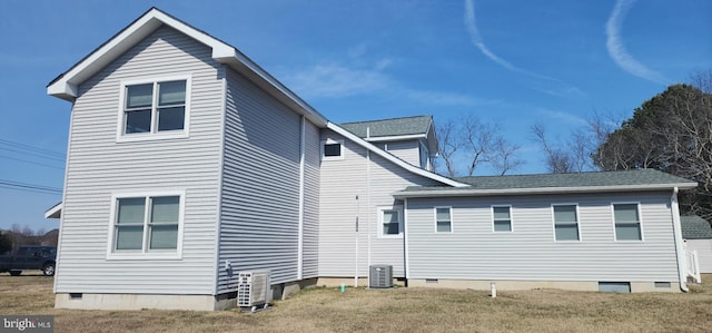 rear view of property featuring a yard, central AC unit, and crawl space