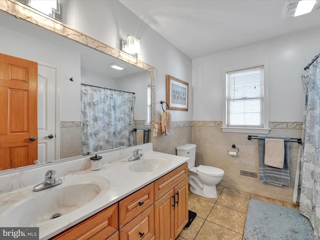 bathroom featuring toilet, tile patterned flooring, a sink, and visible vents