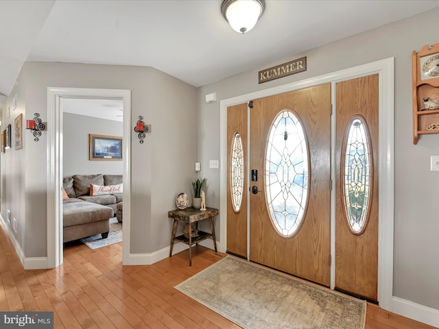 foyer featuring light wood-style floors and baseboards