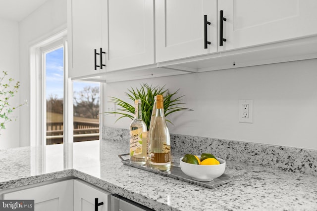 details with white cabinets and light stone countertops