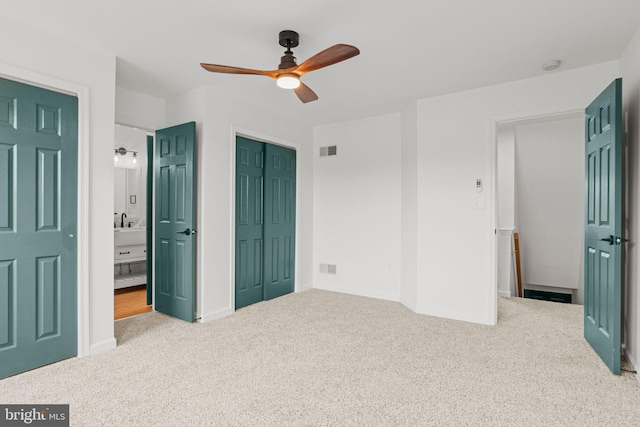 bedroom with carpet floors, a closet, visible vents, and a sink