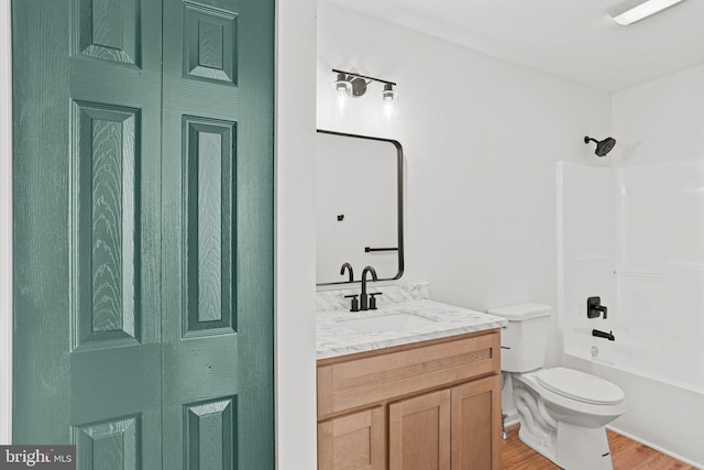 bathroom featuring  shower combination, vanity, toilet, and wood finished floors