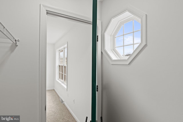 interior space with carpet flooring and baseboards